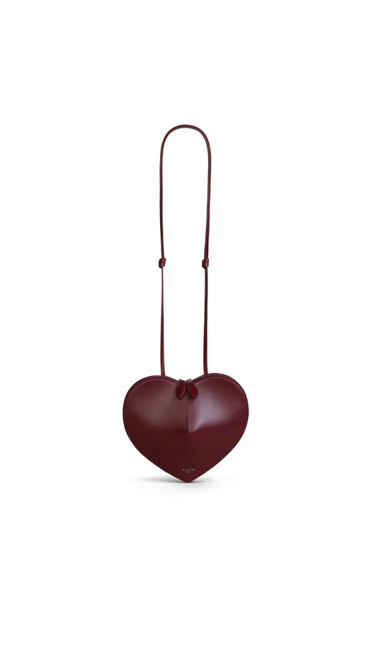 Alaïa Le Cœur crossbody bag in lacquer red — front view | La Parisienne Qatar