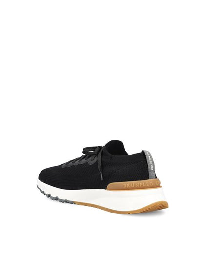 Brunello Cucinelli knitted runners in black cotton — detail view | La Parisienne Qatar