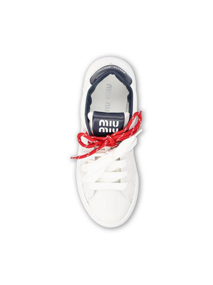Miu Miu leather sneakers in white and blue — side profile | La Parisienne Qatar