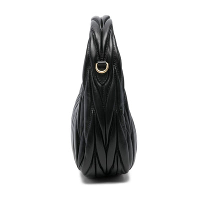 Miu Miu matelassé shoulder bag in black lambskin — side profile | La Parisienne Qatar