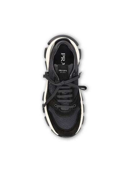 Prada technical mesh and suede sneakers in black — side profile | La Parisienne Qatar