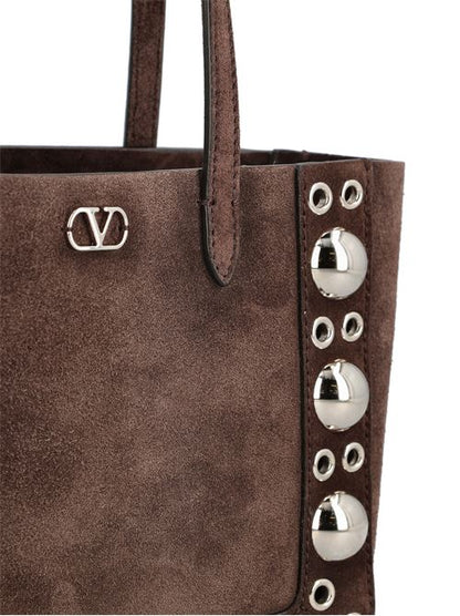 Valentino Garavani Nellcôte mini tote in brown suede — side profile | La Parisienne Qatar