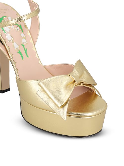 Valentino Garavani platform sandals in gold — side profile | La Parisienne Qatar